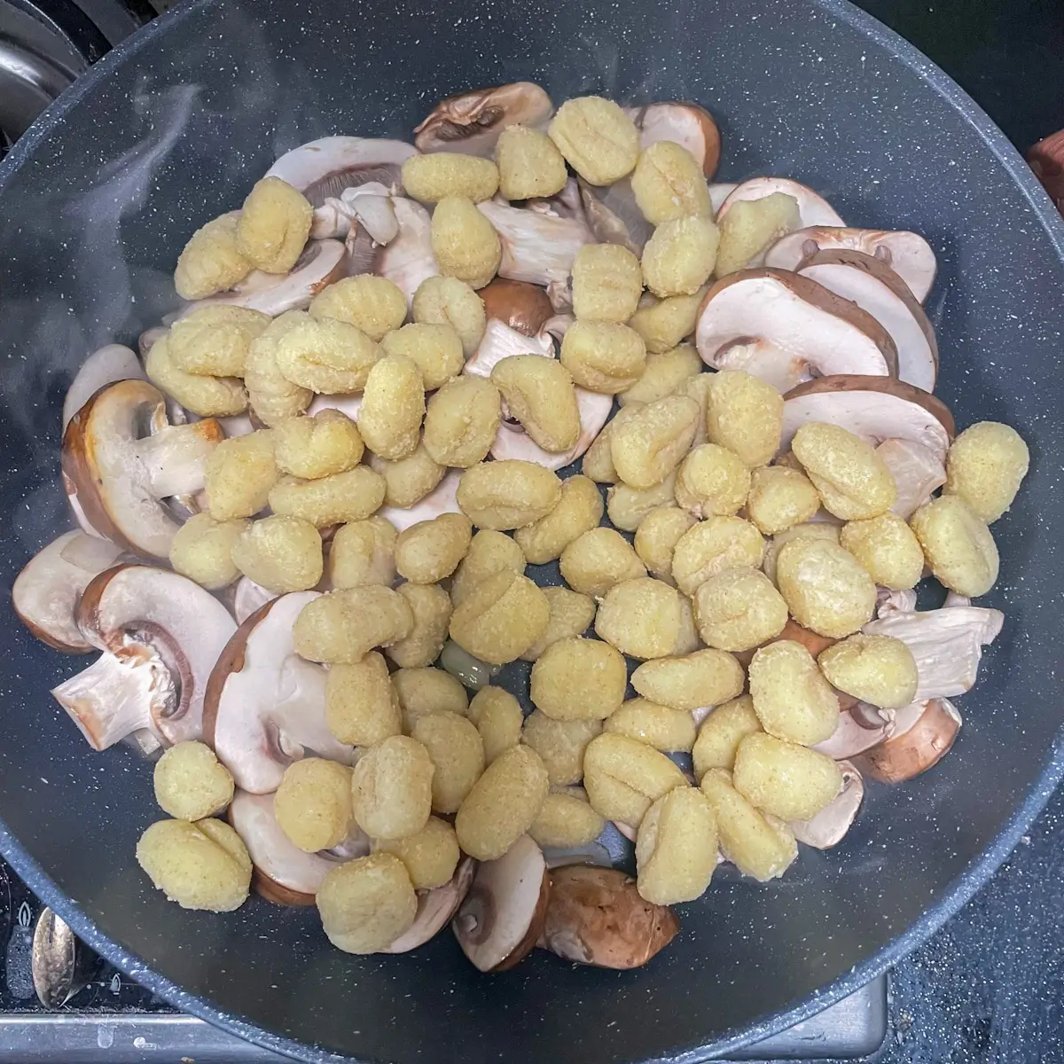 adding the gnocchi to the vegetables