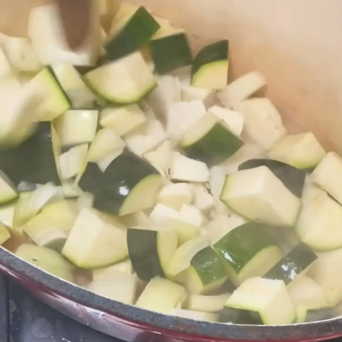 Halloumi cubes frying with courgette and onion