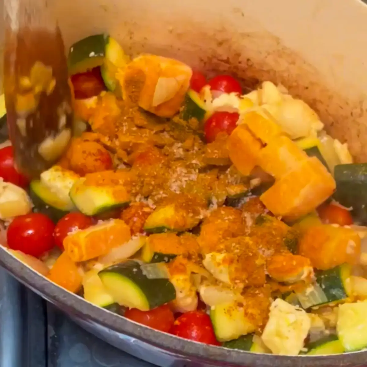 Rice vegetables and spices being added to pan