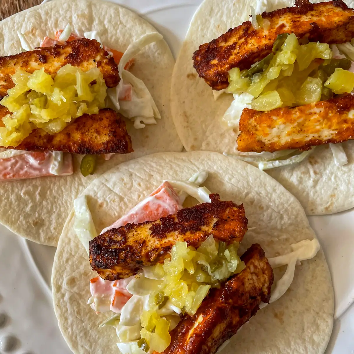 overhead shot of halloumi tacos with slaw and salsa