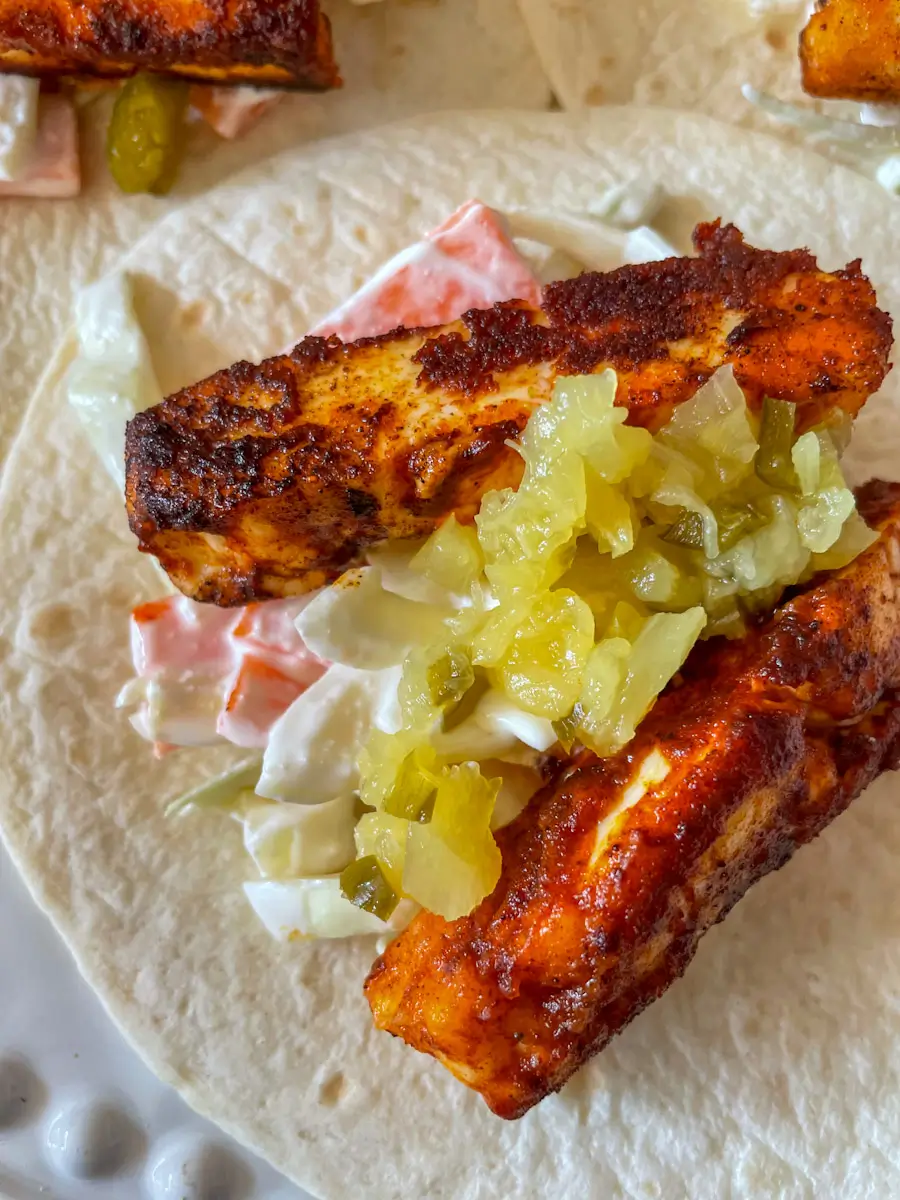 pineapple and jalapeno salsa on top of fried halloumi in a taco