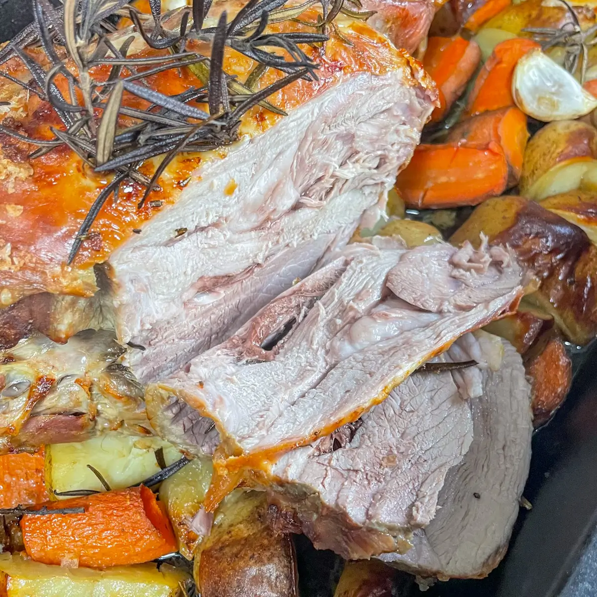 sliced leg of lamb showing juicy meat