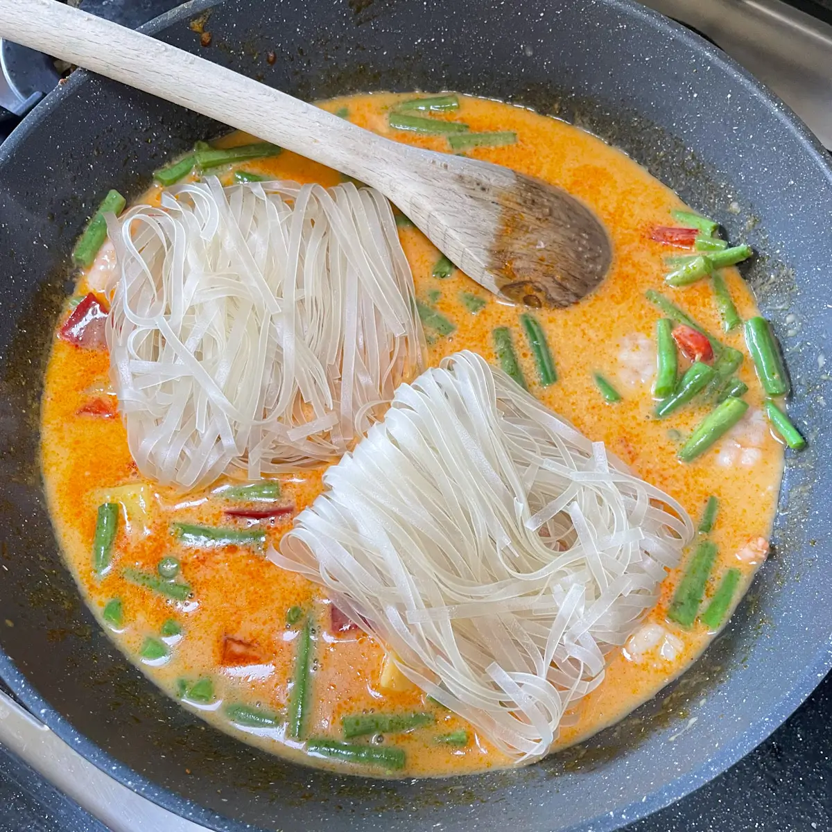 adding flat rice noodles
