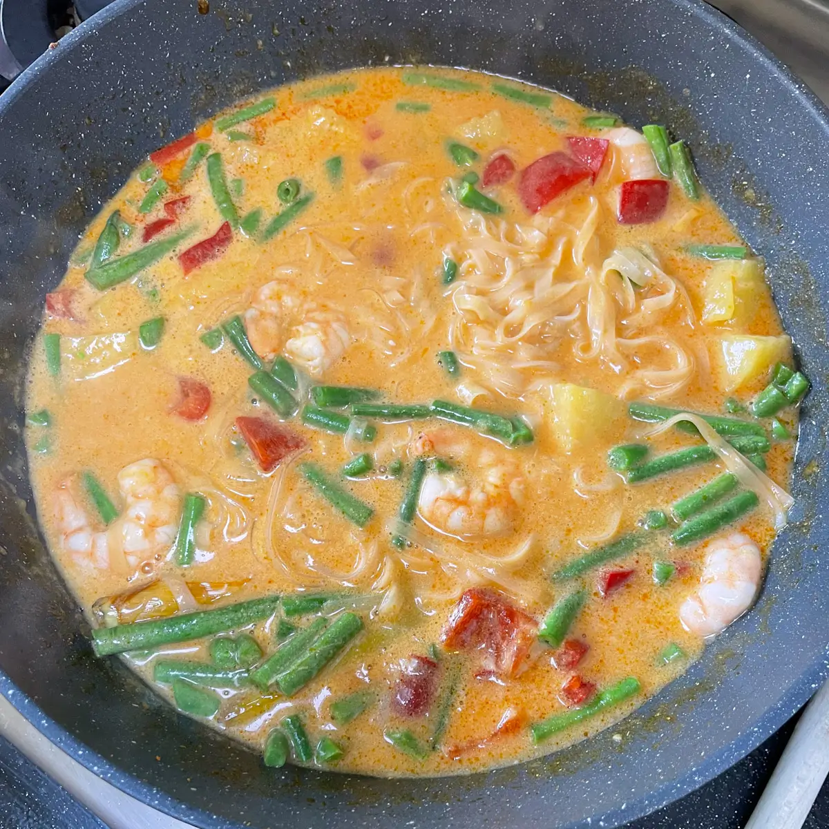 simmering the curry before serving