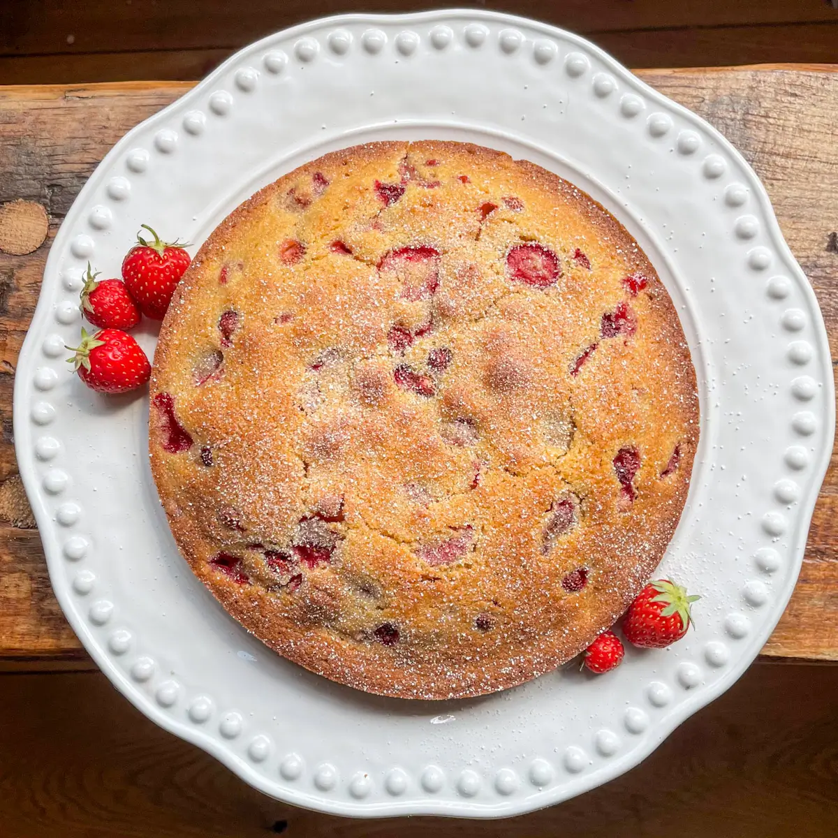 overhead image of a wild strawberry and polenta cake