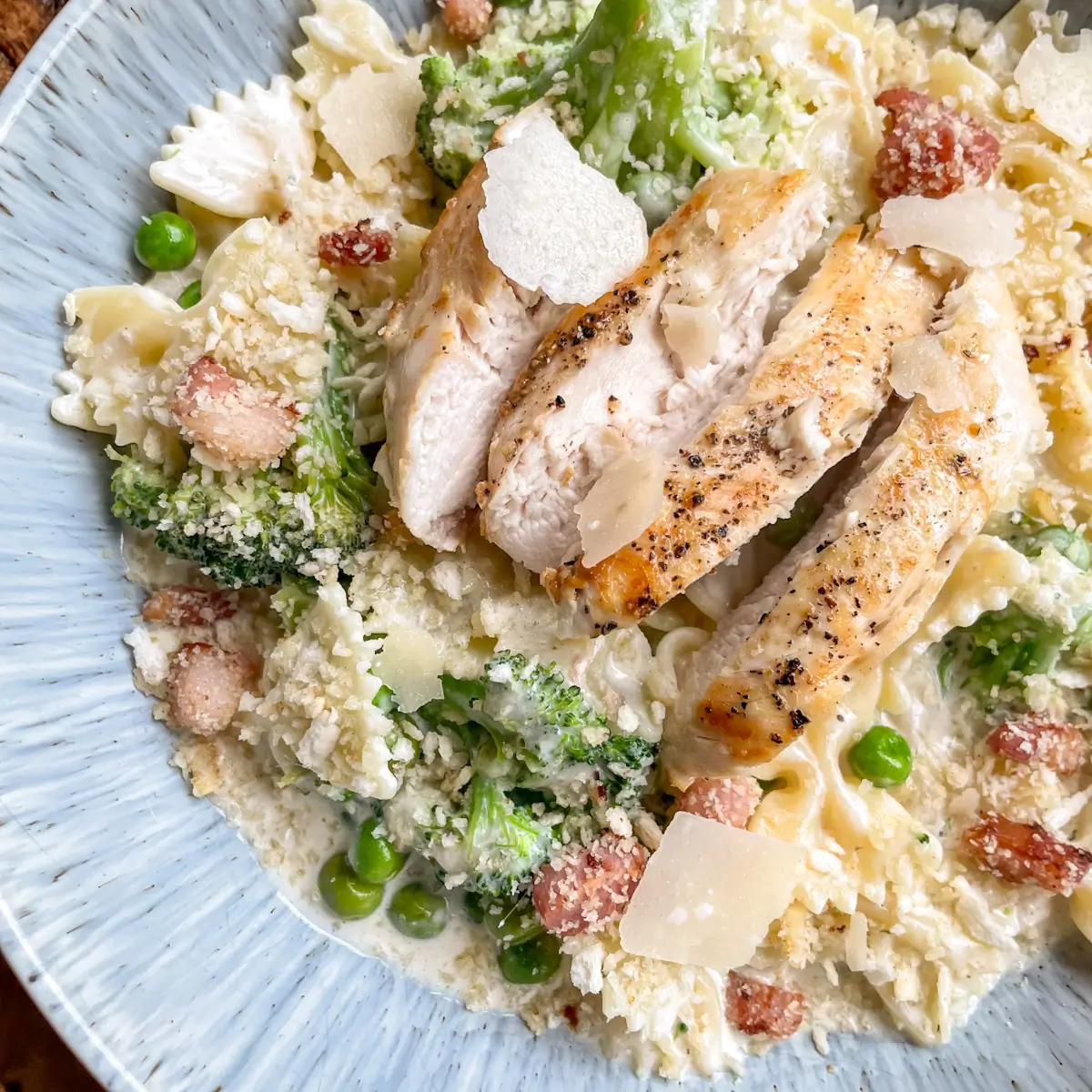 how to serve caesar pasta with chicken in a bowl topped with breadcrumbs