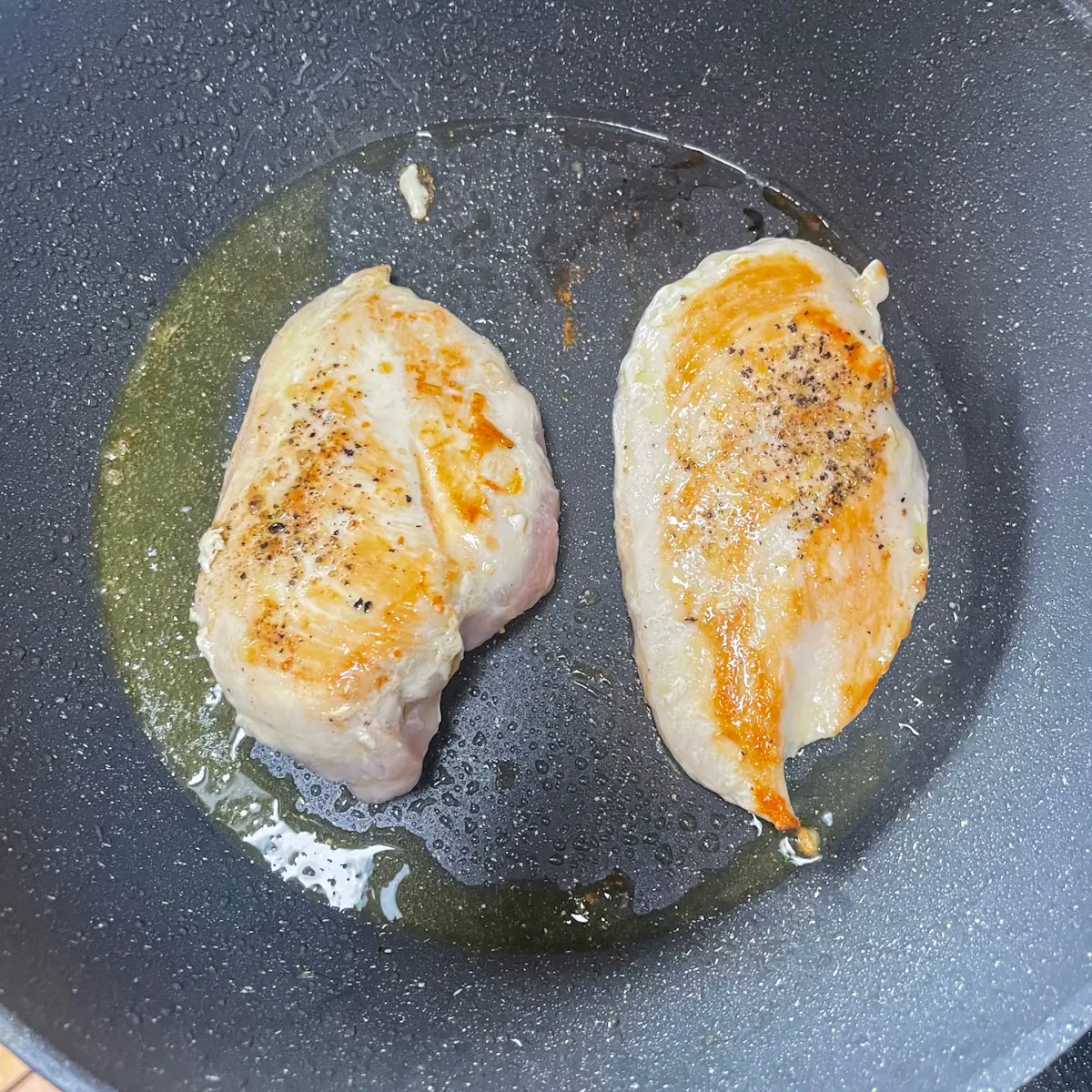 cooking chicken breast fillets in a pan