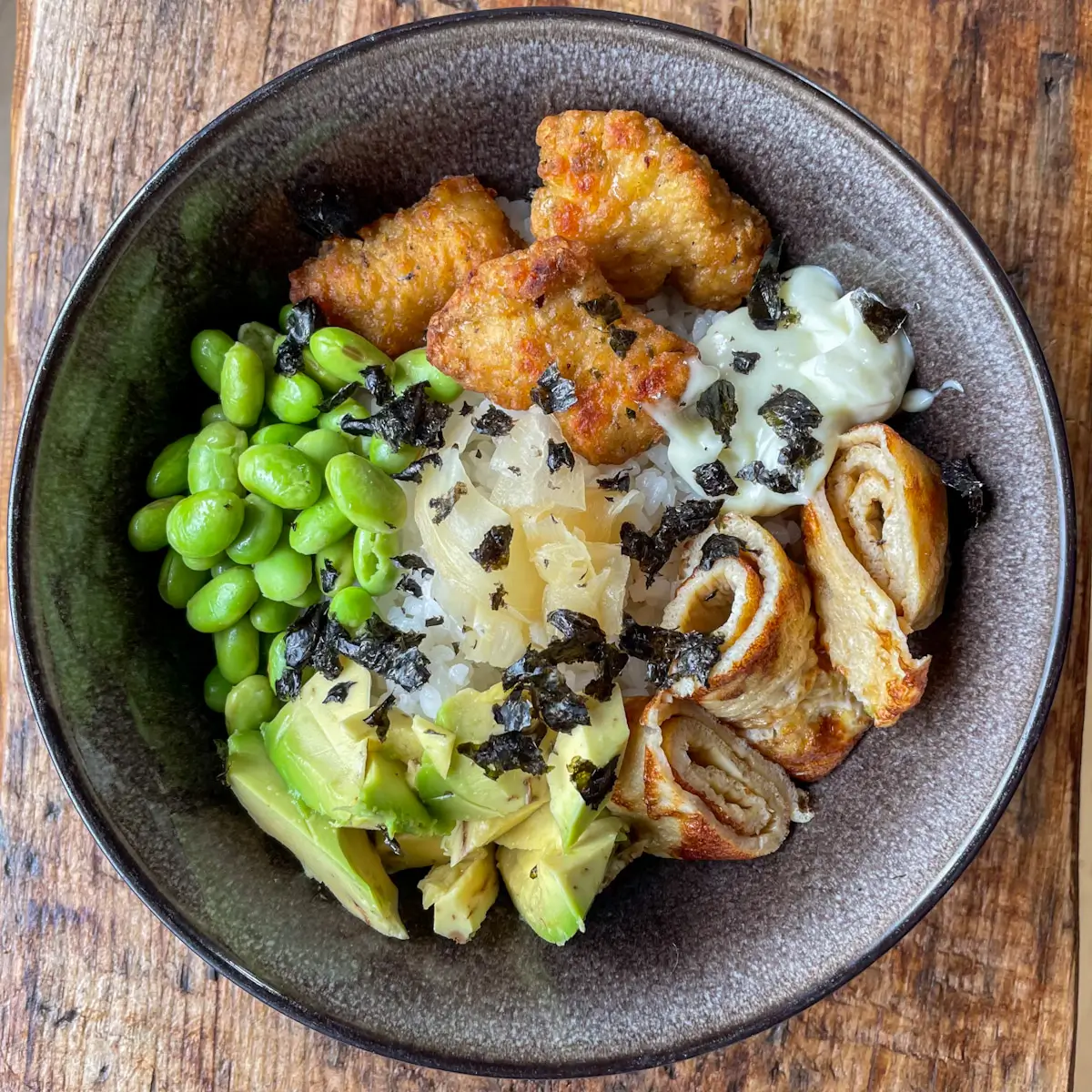 overhead view of a chicken nugget sushi rice bowl