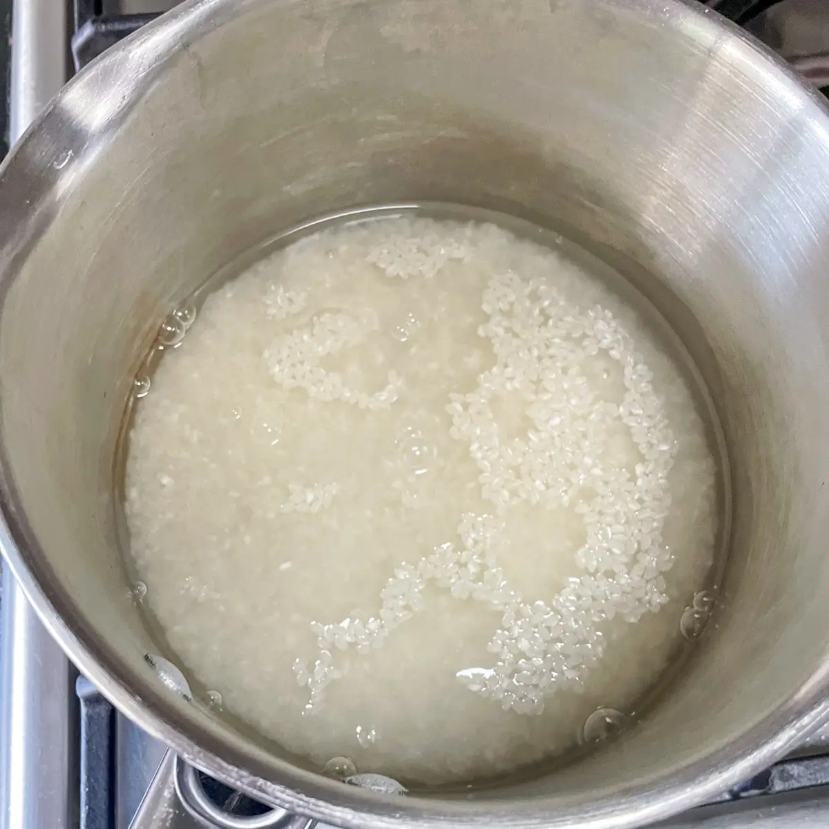 cooking sushi rice in a pan of water