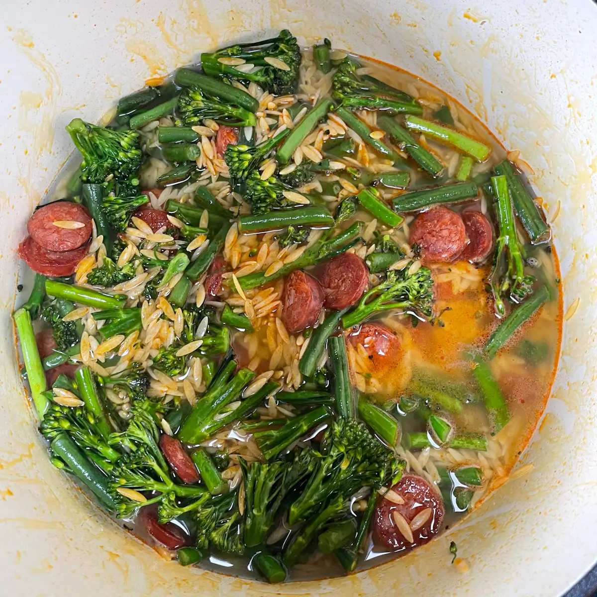 adding the water to the orzo pan