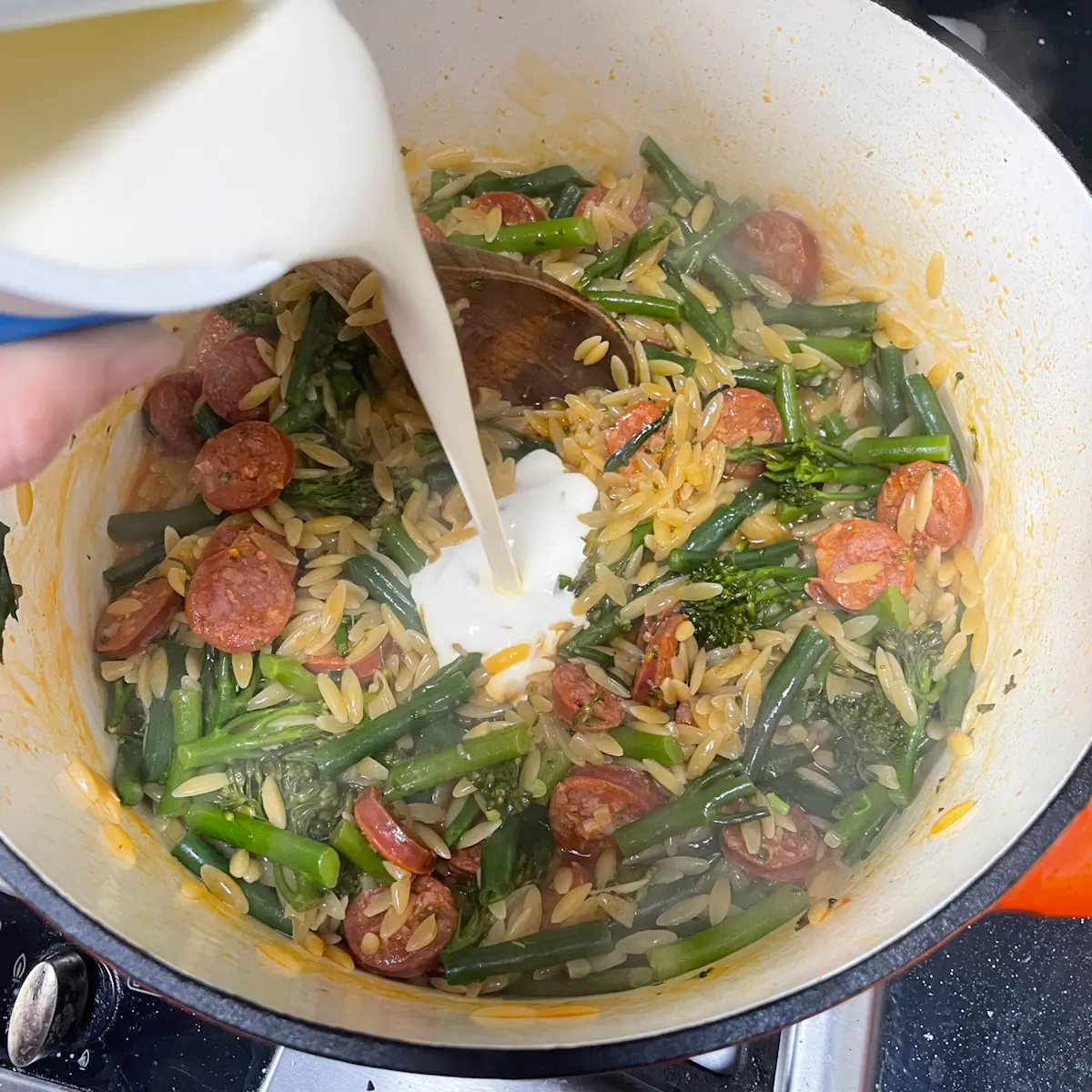 adding cream to the pan