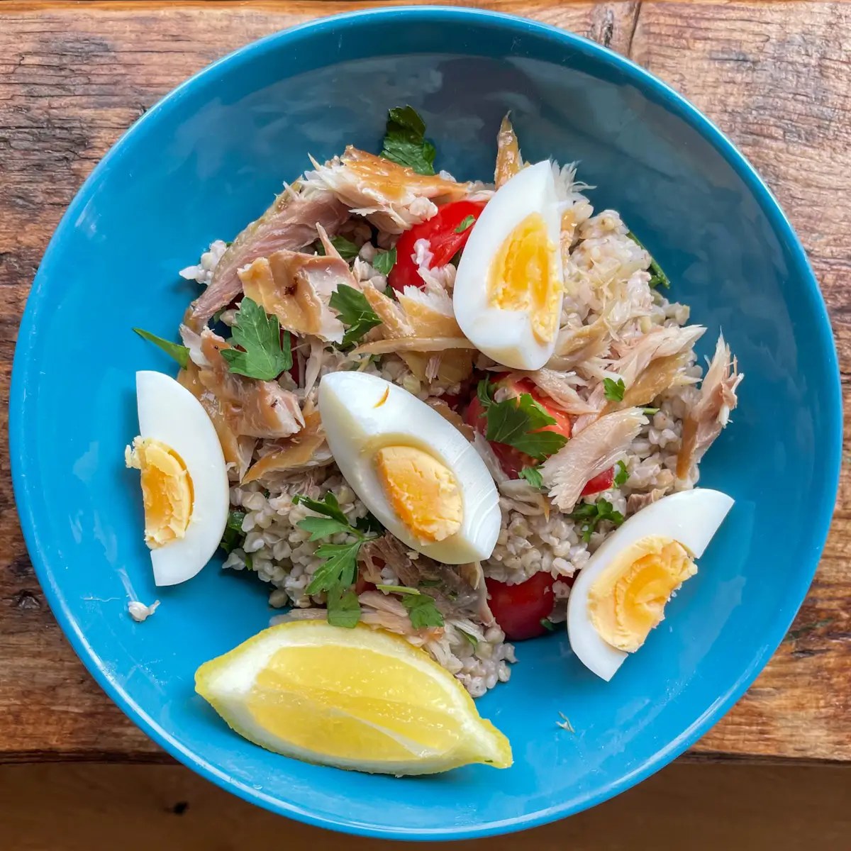 Assembled mackerel and buckwheat salad in a bowl with boiled egg