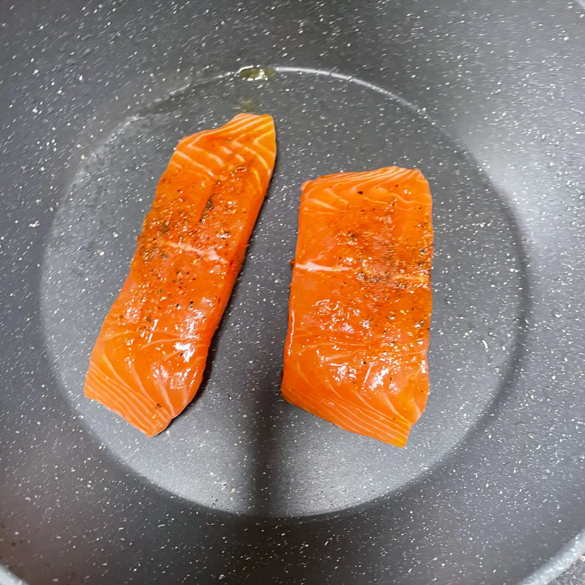 Salmon fillets in a frying pan