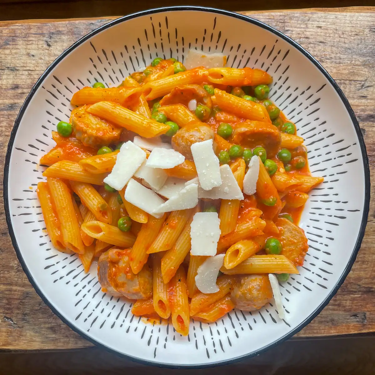 sausage and roasted red pepper pasta topped with parmesan